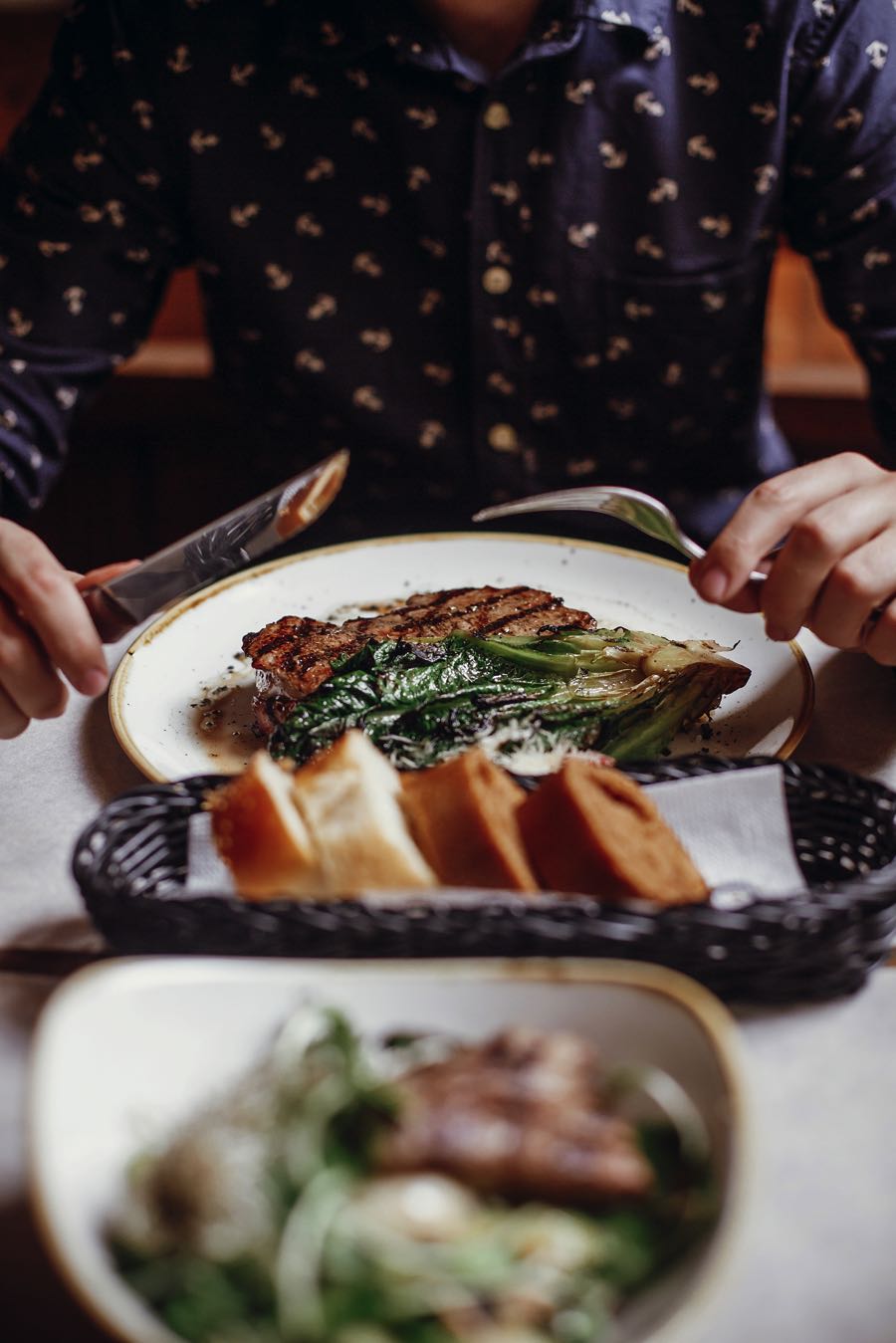 hands-holding-fork-and-knife-and-eating-delicious-F7WCLNN.jpg